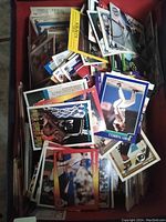 Photo showing pile of assorted baseball, hockey, basketball, and Ticat trading cards in shoe box