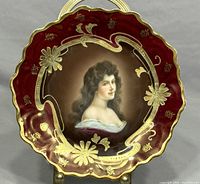 Front view of the antique Royal Vienna plate showing hand-painted portrait and gold floral decoration on burgundy background.