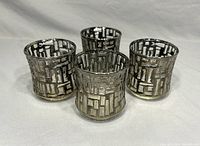 Four MCM Libbey Artica platinum overlay glasses grouped together, showing the geometric textured pattern and metallic finish.