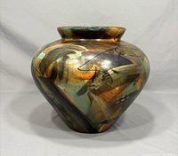 Front and side view showing full vase shape and multicolor abstract Raku glaze with gold and bronze metallic tones.