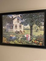 Framed puzzle showing a detailed country house scene with a woman hanging laundry outdoors among pumpkins and flowers under a tree.