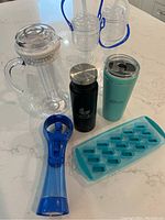 Photo showing entire set with plastic pitcher, ice cube tray, two insulated bottles, spritzer fan, and two slushy holders