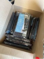 Box of 14 black Whitmor Deluxe Suit Bags, still in original packaging, stacked inside an open cardboard box.