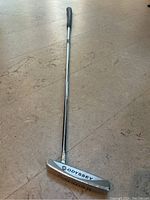 Full view of the Odyssey White Hot putter showing the full length of the shaft, grip, and club head.