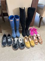 Photo showing the entire footwear lot including boots, shoes, loafers, wedges, slippers, and trainers