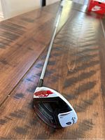 Full view of the TaylorMade Aeroburner TP 3 wood showing club head and shaft on wooden surface.