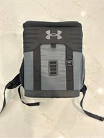 Top view of the black and grey Under Armour cooler bag showing the logo and straps.