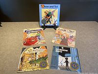 Five Robert Munsch books shown on a tabletop, clean copies, titles readable.