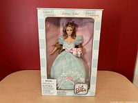 Front view of boxed Barbie Birthday Wishes collector doll with visible gown details and Barbie logo.