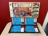 Full set including game box and two blue boards with red and white game pegs, displayed open.