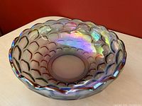 Side angled view of the smoked carnival glass bowl showing the scalloped edge and iridescent optic thumbprint pattern under light.