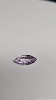 Top view of marquise cut pink purple sapphire showing shape, color and clarity.