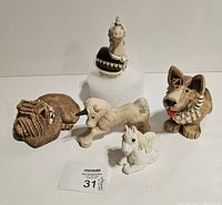 Lot of five Artesania Rinconada and similar mythical animals figurines arranged for display, showing full group.
