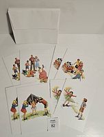 Photo showing 8 Dick and Jane illustrated cards fanned out with envelopes behind.
