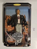 Front view of Harley Davidson Ken Doll in original box with motorcycle and desert scenery background, labeled Collector Edition.