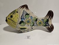 Side view of the large Tonala pottery fish showing detailed floral hand-painted decoration and overall shape.