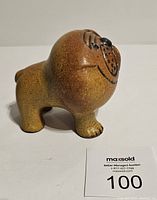 Front-side angle of mini bulldog sculpture showing face and legs.