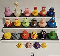 Full arrangement of 22 rubber ducks on three-tier display, shows all different characters and sizes