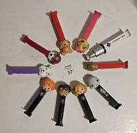 Top-down view of the 10 PEZ dispensers arranged in a circle showing character heads and colors.
