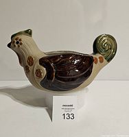 Side angle showing overall shape, colors, and patterns of the pottery chicken planter.