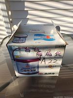 Box showing Sunpentown ST-60B Thermal Cooker with printed product image and model number.