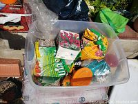 Tote containing multiple bags of potting soil and mixes, clearly showing variety and condition of the bags.