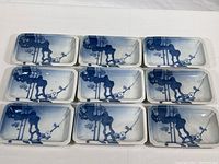 Photo showing all nine blue and white rectangular appetizer plates arranged in a 3x3 grid on a white surface, highlighting size and consistent design across all plates.