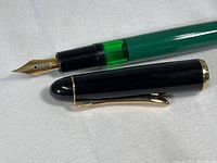 Pelikan 120 fountain pen uncapped showing gold nib and green translucent ink window section