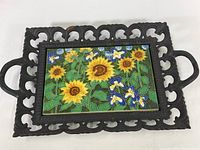 Full view of the wrought iron platter with the colorful ceramic tile showing sunflowers and blue irises.