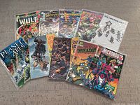 Photo showing all 10 comic books with visible titles including Wulf, Timespirits, Terminator, Ape City, Walking Dead, Planet of the Apes, Lone Wolf, Micronauts, Dreadstar spread out for display.
