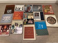 Books laid out on floor showing full collection and cover details