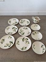 Full set arranged on the floor with 6 plates, 3 bowls, and 1 creamer
