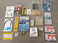 Overview photo showing the entire collection of fishing ephemera and vintage fishing items laid out on the floor.