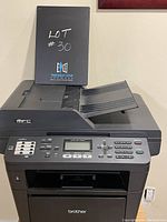 Front and top view of the black Brother MFC-8710DW multifunction printer showing the automatic document feeder and control panel.