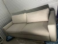 Front-left view of sofa showing cushions and arm