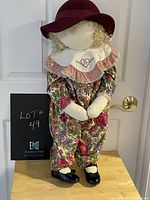 Vintage Time Out Kid doll standing against a door, showing full outfit and hat