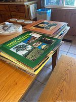 Stack of vinyl records including Hank Williams 'In the Beginning' and Super Country 82.