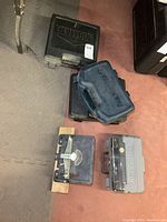 Overview photo showing all cases containing tools on the floor, including Dremel and Mastercraft cases and cordless drill cases