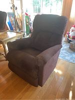 Full view of brown corduroy LaZBoy rocker recliner from front-left angle in living room environment.