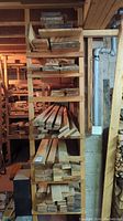 Shelving unit stocked with multiple stacks of tongue and groove wood boards