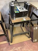 Full view of the Delta planer mounted on wheeled stand