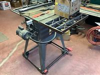 Front view of table saw on wheeled stand with blade guard removed