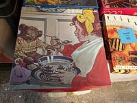 Close-up of the 1985 Breakfast with Teddy puzzle showing a girl feeding a teddy bear with a spoon.