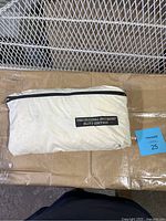 Zipped pouch containing the original Bug Shirt Elite Edition with visible label on pouch.