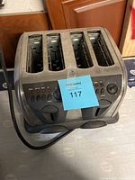 Four-slot commercial toaster showing front panel controls and power cord.