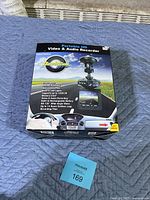 Photo of unopened retail box of Dashcam Pro Portable HD Video & Audio Recorder showing branding and main features.