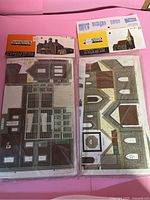 Flat cardboard sheets with parts printed for model buildings, packaged under Superquick brand.
