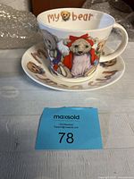 Front view of ceramic mug and saucer showing teddy bear in red jacket and 'My Bear' text.