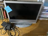 Sony Wega 19-inch TV with silver frame and base, powering on. Power cable visible in front.