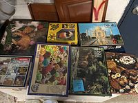 Overview photo showing all seven puzzles with various images and box conditions.